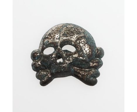 A German SS early type skull cap badge with RZM and makers mark ST &amp; LL for Steinhauer and Luck Ludenscheid'. With twin '