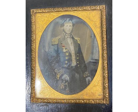 A fine Victorian photograph of Commander Astley Cooper Key in Naval uniform, the ribbons and braid highlighted in red and gil