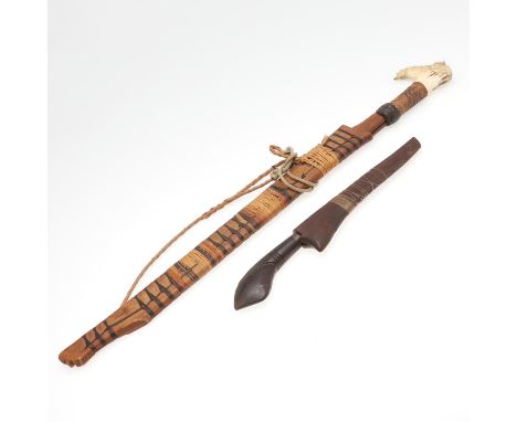 A Dyack 'Headhunters' sword with a slightly curved pointed sharpened 52cm blade on a woven and horn mounted handle, the horn 