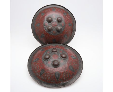 A pair of 19th century Indian Benares type circular shields, with raised 'buttons' to the centre, allover engraved decoration