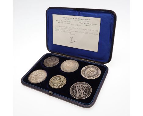 An unusual collection of silver roundells, four similar engraved to one side with a classical subject to include a female hea