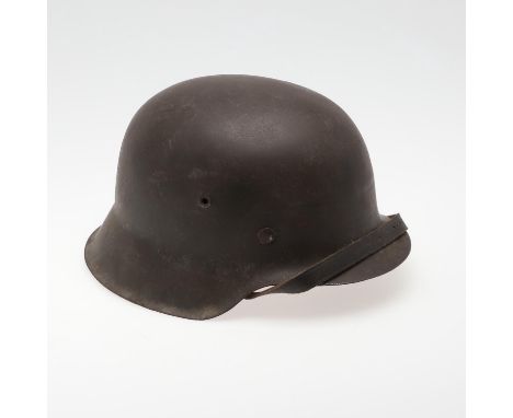 A Second World War or later finished M42 type steel helmet shell, with worn dark green painted finish with no decals. The hel