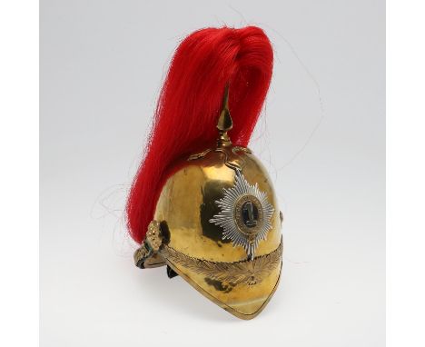 An 1871 pattern helmet with 1st King's Dragoon Guards helmet plate with the number '1' against a black ground and many pointe