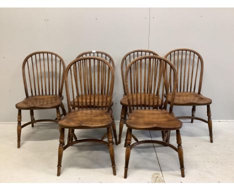 A set of six oak Windsor comb back dining chairs with crinoline stretchers, width 48cm, depth 43cm, height 94cm. Condition - 
