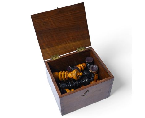 A turned wooden chess set in ebony and boxwood, king 10.5cm high, in a hardwood box. Condition - good.