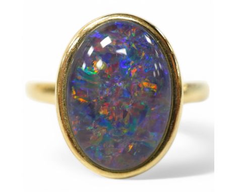 A modern 9ct gold and oval opal triplet set ring, size P/Q, gross weight 4 grams. Condition - good