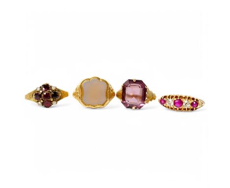A group of four rings, comprising: a chalcedony signet ring with engraved floral shoulders, size L, partial British hallmarks