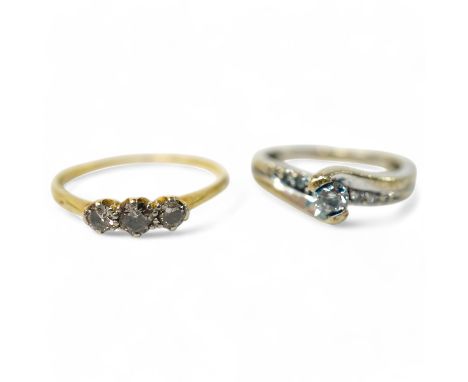 A small yellow metal and three stone diamond set ring, size R/S and a modern 9kt and single stone diamond ring, with diamond 