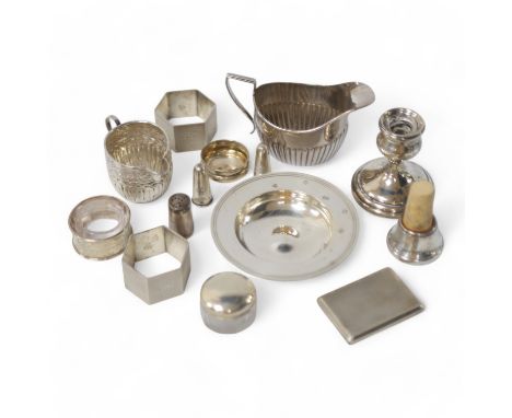 Small silver including two cream jugs, one demi-fluted, Birmingham, 1894, a dish, a dwarf candlestick, napkin rings, toilet j