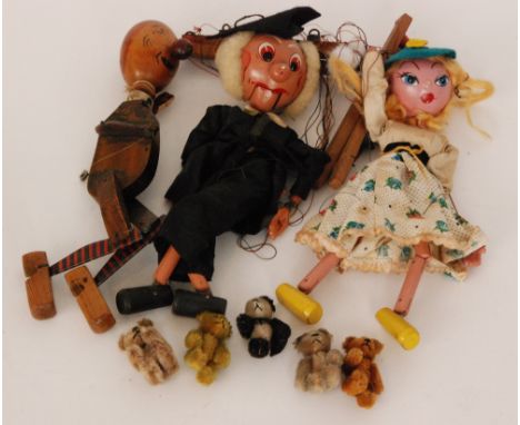 A collection of four Schuco miniature teddy bears with moveable limbs including a panda example together with an unboxed Pelh
