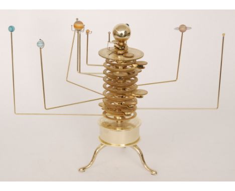 A replica brass twelve planet Orrery, some with their own moons on a central gear mechanism on splayed tripod legs, height 35