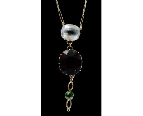 An early 20th Century 9ct garnet, peridot and clear paste pendant, the oval mixed cut garnet suspended below a cushion cut cl