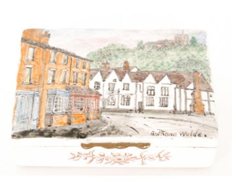 A late 20th Century Bilston enamel box of rectangular form, the hinged lid decorated with a scene of Kinver High Street, sign