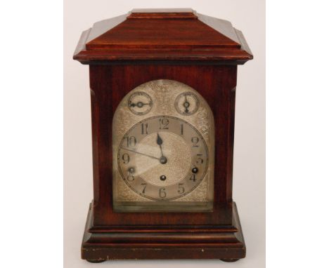 An early 20th Century mahogany cased bracket clock with arched silvered dial and two subsidiary dials chime/silent and slow/f