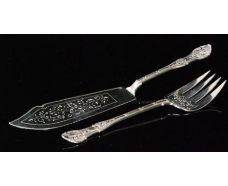 A Victorian hallmarked silver fish knife and fork with shell and scroll handle above pierced blade, weight 11.5oz,London 1883