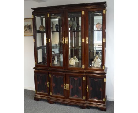 A late 20th Century break-fronted display cabinet in the Chinese taste, the cornice pediment above four glazed doors and with