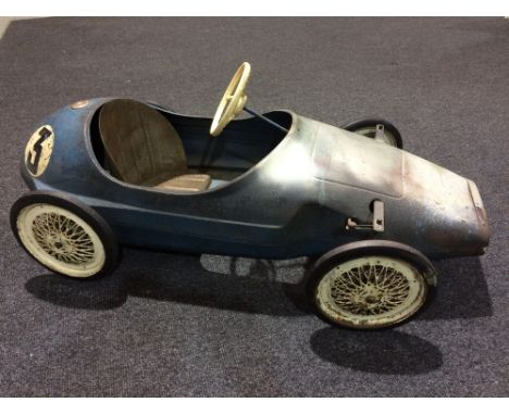 A Tri-ang pressed steel grand prix pedal car, possibly a Vanwall model, length 118cm, some damage and losses.