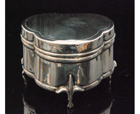 A George V hallmarked silver ring box of trefoil outline with engine turned design, velvet lined interior and raised on three