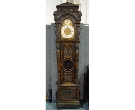 A late 19th Century carved oak longcase clock of large proportions with eight day three train musical movement striking on ei