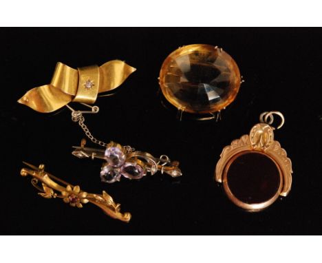 Two Victorian 15ct brooches to include a diamond set ribbon brooch and a ruby set example, a citrine brooch, a 9ct rose gold 