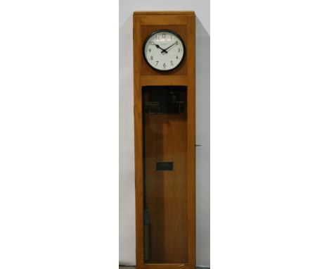 A 20th Century Magneta electric impulse clock model 37, serial number 11584 with pendulum in oak case, height 137cm