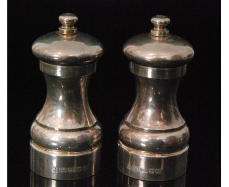 A pair of modern salt and pepper mills each of plain waisted from engraved S and P to button finials, heights 11cm, London 20