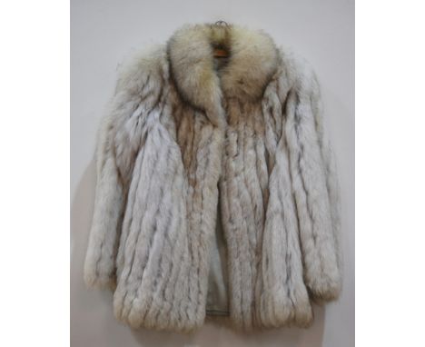 A lady's vintage half length blue arctic fox fur coat, labelled Saga Fox to the blue rayon lining, approximately a size 12