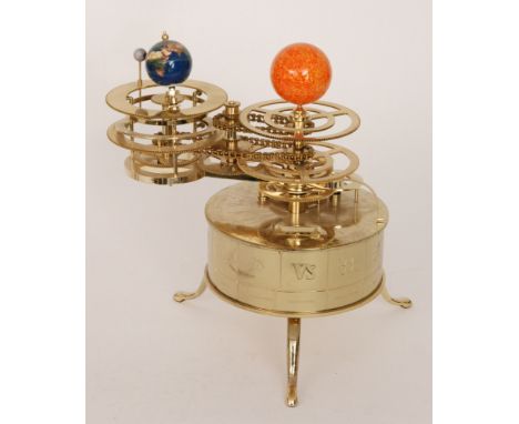A replica brass three planet Orrery clock with chain driven mechanism, on a cylinder base inset with a four digit counter to 