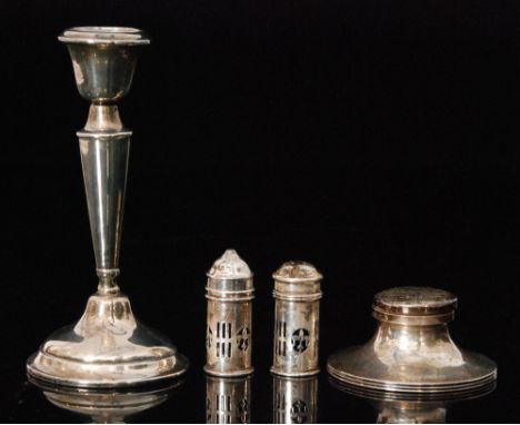 Four items of assorted hallmarked silver, a cylindrical salt and pepper, a capstan ink well and a candlestick, various styles