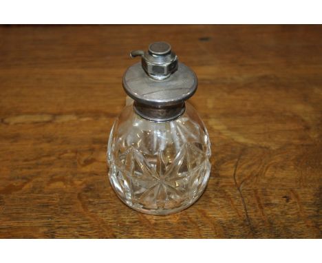 Edwardian white metal mounted perfume atomiser, with engine turned cap and clear glass lower section