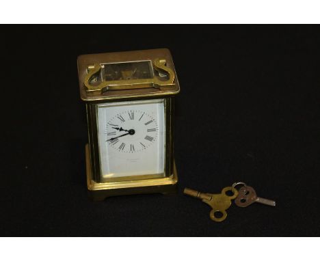 Jackson Paris brass carriage clock, with a signed white enamel dial 