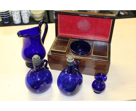 George III rosewood tea caddy, of sarcophagus from, with two lidded compartments and a central bowl, 31cm diameter, together 