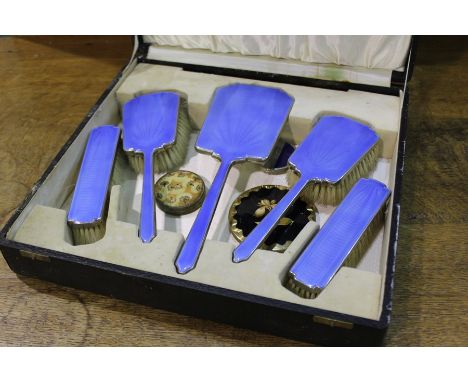 Blue enamel decorated dressing table set, consisting of hand mirror, two hair brushes and two clothes brushes, housed in a fi