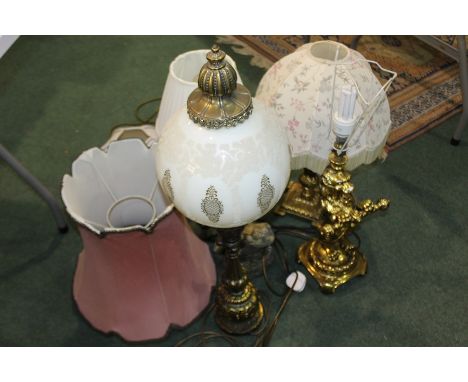 Gilt metal lamp, with figures to the stem, together with a resin lion lamp and other lamp and a frog statue