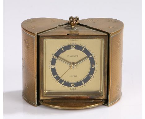 Europa travel alarm clock, the gilt metal oval case with engine turned and foliate decoration, opening to reveal the alarm cl