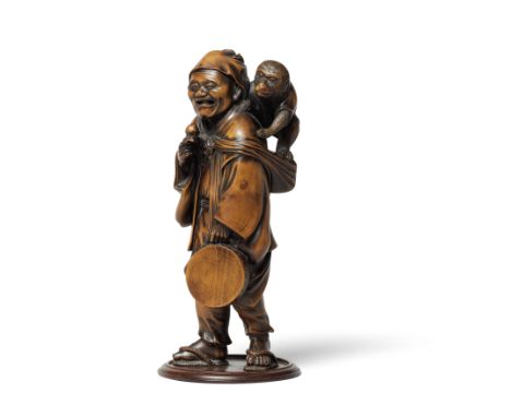 A WOOD OKIMONO (TABLE ORNAMENT) OF A SARUMAWASHI (MONKEY TRAINER)Meiji era (1868-1912), late 19th/early 20th centuryStanding,