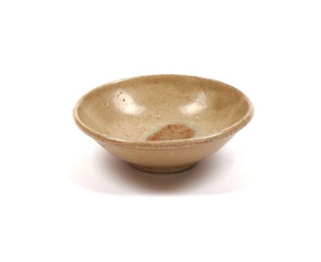 A SMALL CHINESE CREAM GLAZED SHALLOW BOWLTang dynasty or later10.5cm diameter, fitted box (2)Unglazed light brown patch to th