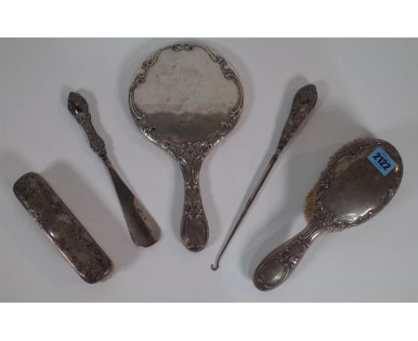 A VICTORIAN SILVER MOUNTED DRESSING TABLE SET (QTY)Comprising a hand mirror, two brushes, a shoe horn and a button hook, a mo