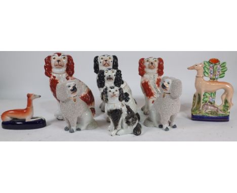 A GROUP OF NINE STAFFORDSHIRE FIGURES OF DOGS (9)To include two pairs, and two formed as greyhounds the largest 25cm highThe 