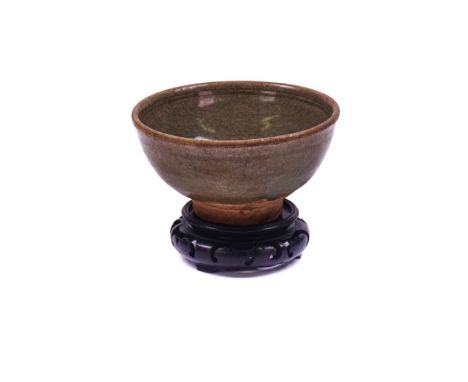 A CHINESE CELADON GLAZED BOWLMing dynastyCovered in a crackled celadon glaze stopping short of the footrim on the exterior, 1