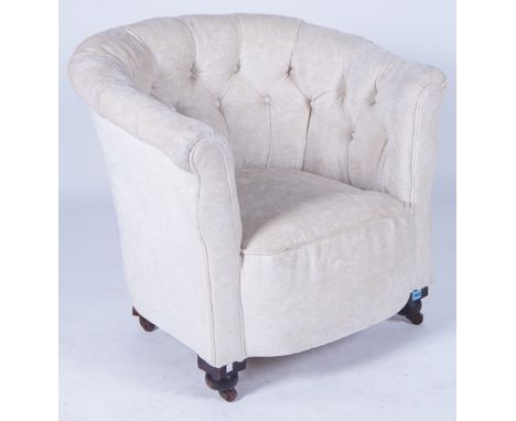 AN EARLY 20TH CENTURY MAHOGANY FRAMED TUB CHAIRWith button back upholstery on bun feet 77cm wide; 72cm high