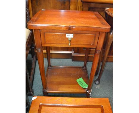 A modern mahogany coloured lamp table with single drawer and a solid under tier