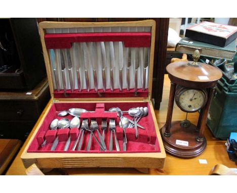 A box of cased cutlery together with a mantle clock