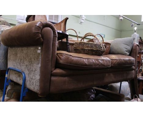 a large two seater brown leather chesterfield style sofa