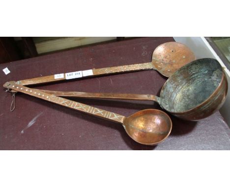 Three unusual hanging beaten copper ladle spoons