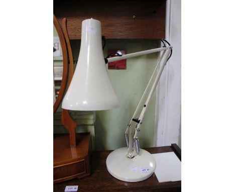 A cream angle-poise desk lamp