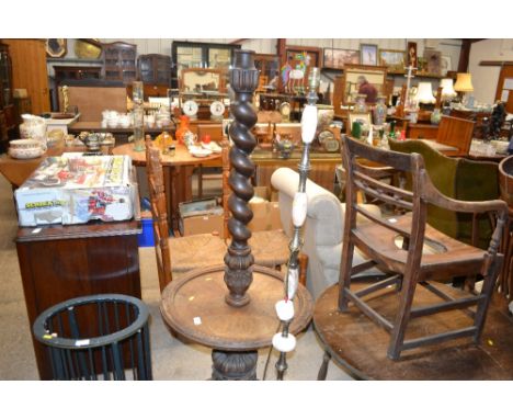 A carved oak lamp standard with barleytwist column and foliate decoration; and an onyx and brass standard lamp