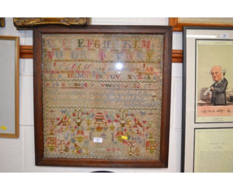An oak framed needlework sampler 
