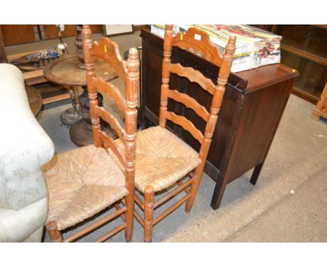 A pair of pine and rush seated ladder back dining chairs