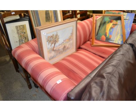 A red and pink striped two seater Chesterfield type sofa
